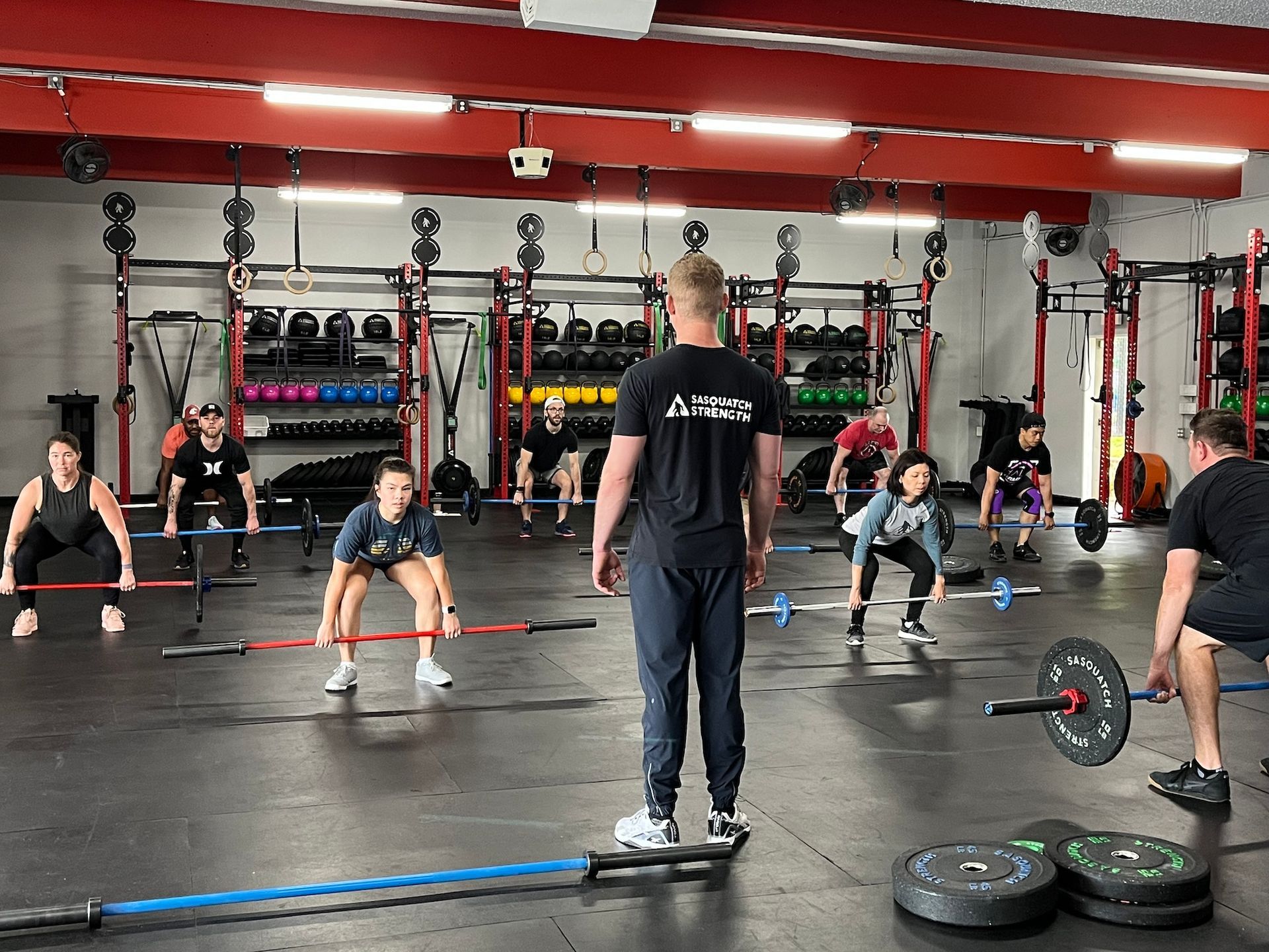 A group of people are doing exercises in a gym. A group of people are doing exercises in a gym.