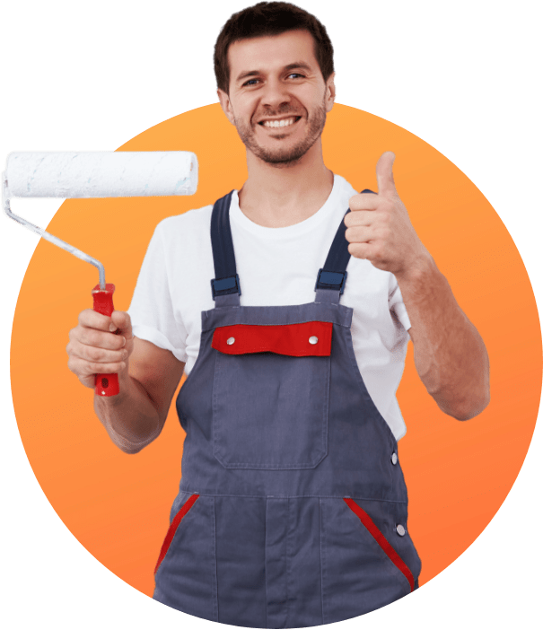 A man in overalls is holding a paint roller and giving a thumbs up.