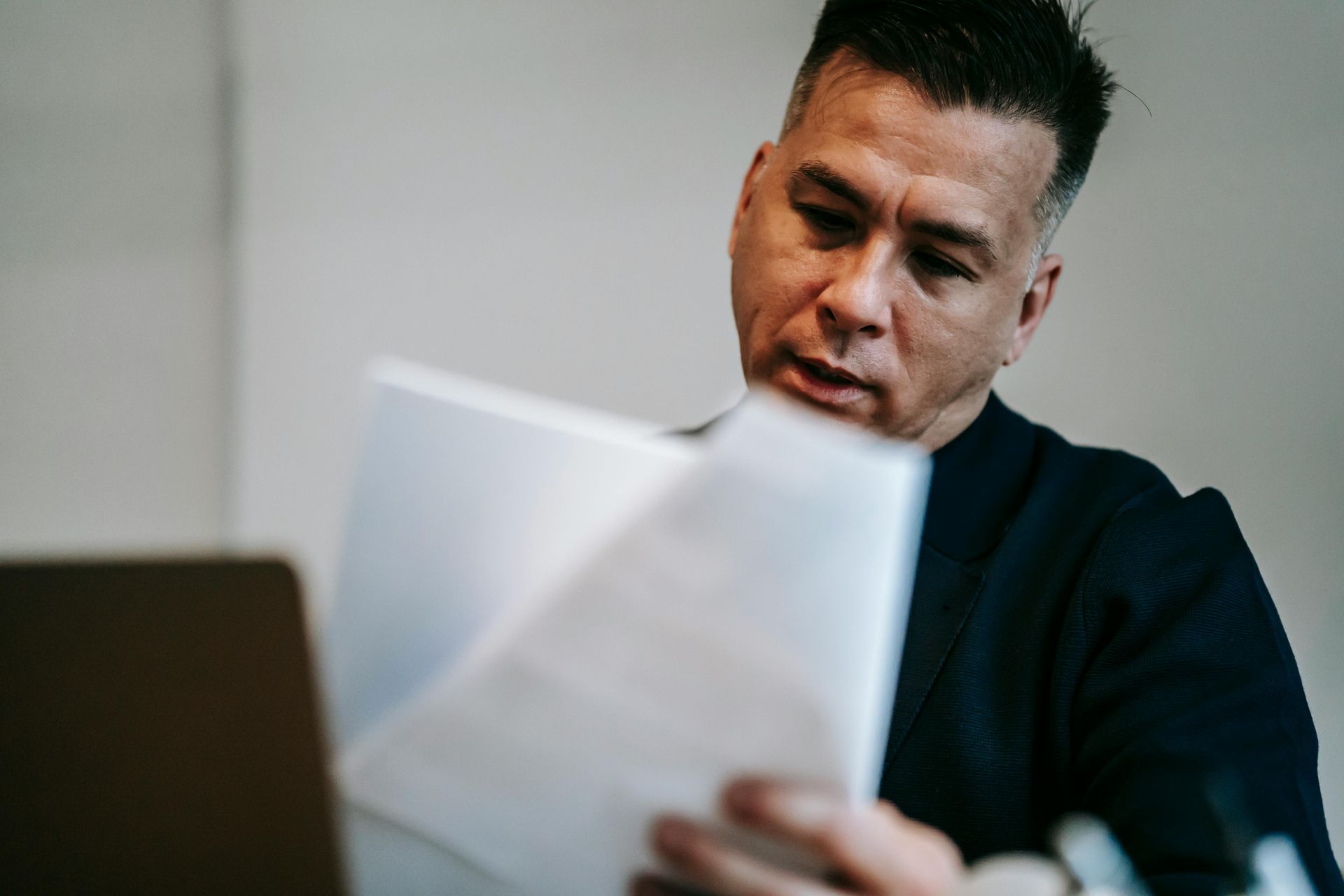 Professional reading official letter during federal investigation defense consultation