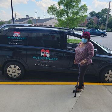 Woman Standing Next To Car — Smyrna, DE — Acts From The Heart