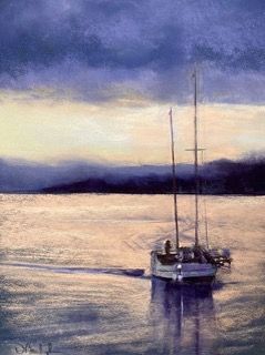 Sailboat on calm water at dusk, with a moody purple sky and distant shoreline.