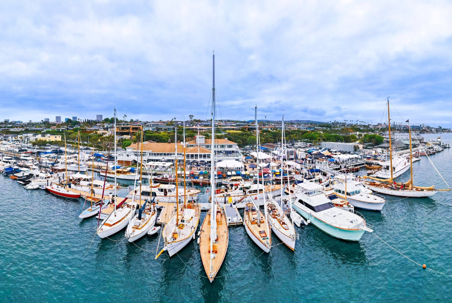 Marina filled with sailboats docked on turquoise water under a blue sky