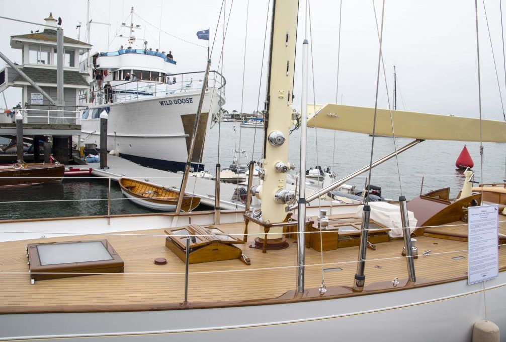 Sailboat deck in marina with yachts and docked boats in the background