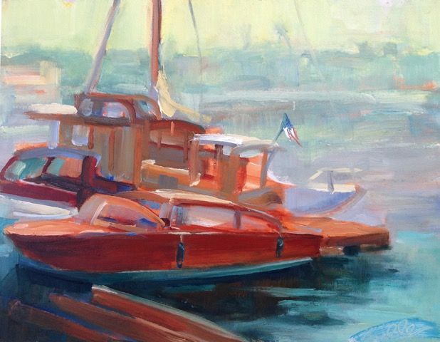 Red and orange boats docked on calm blue water in a hazy marina scene