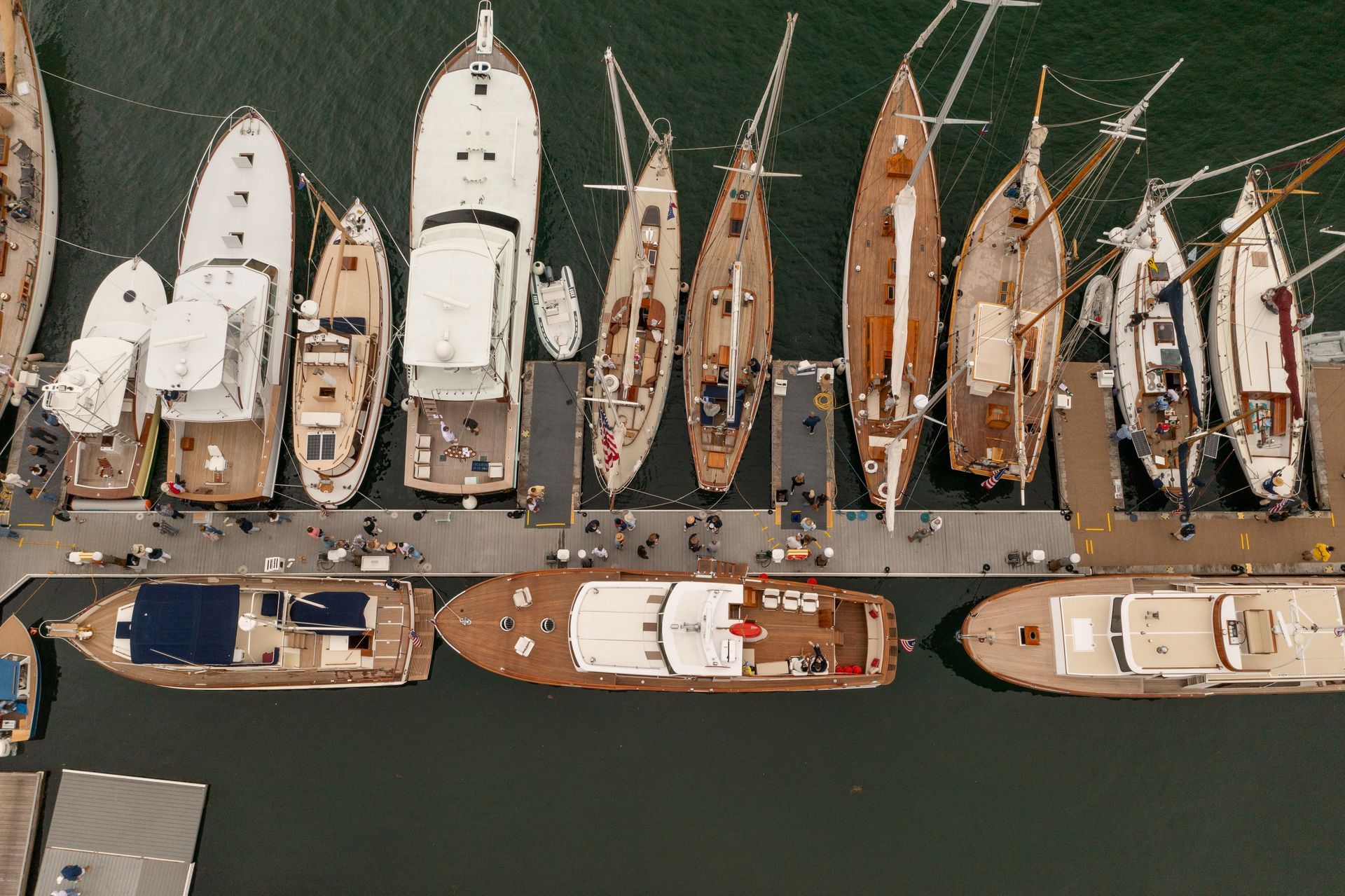 Aerial view of yachts and boats docked side by side in a marina basin