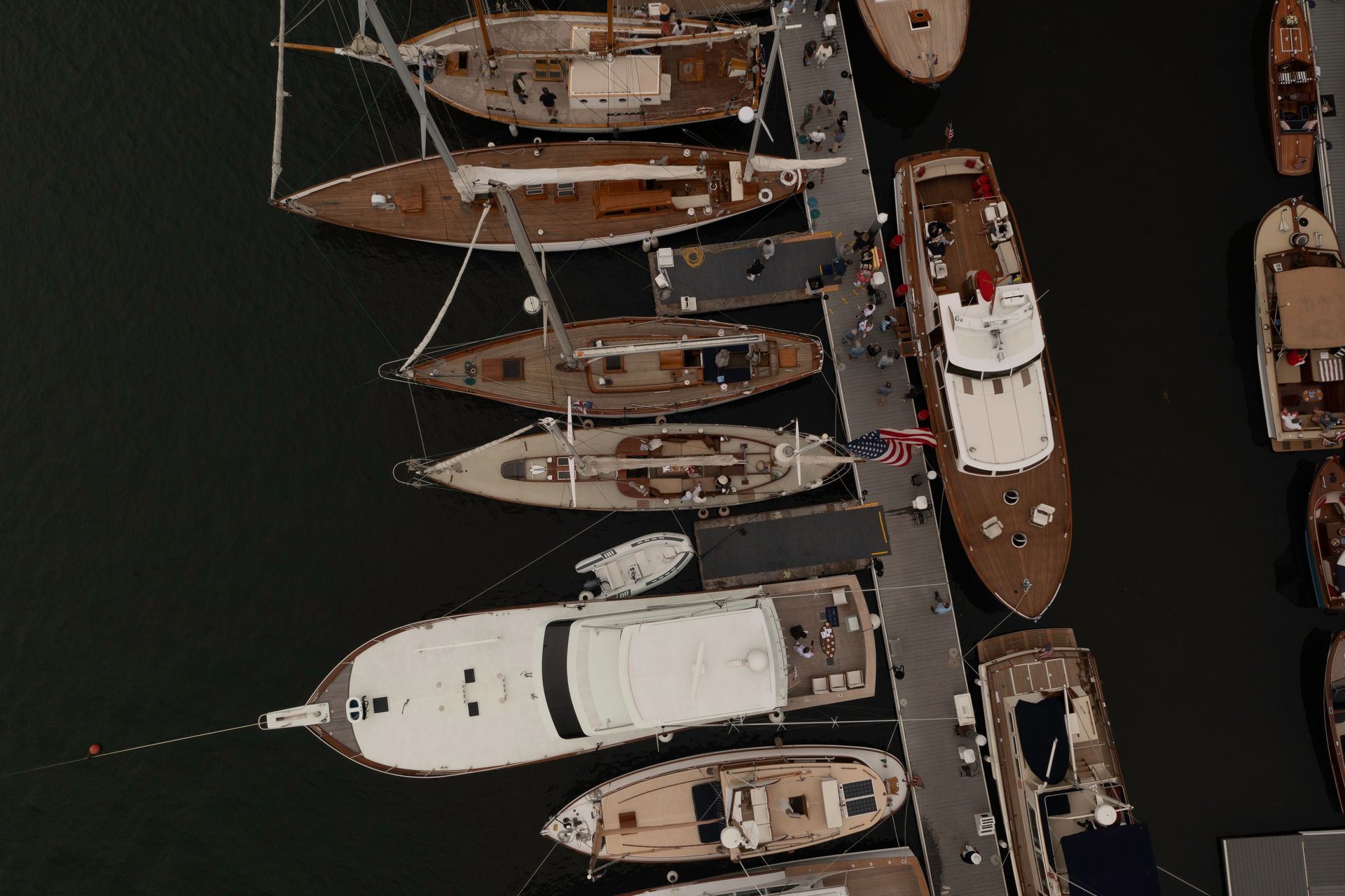 Overhead view of boats docked along a marina pier at night