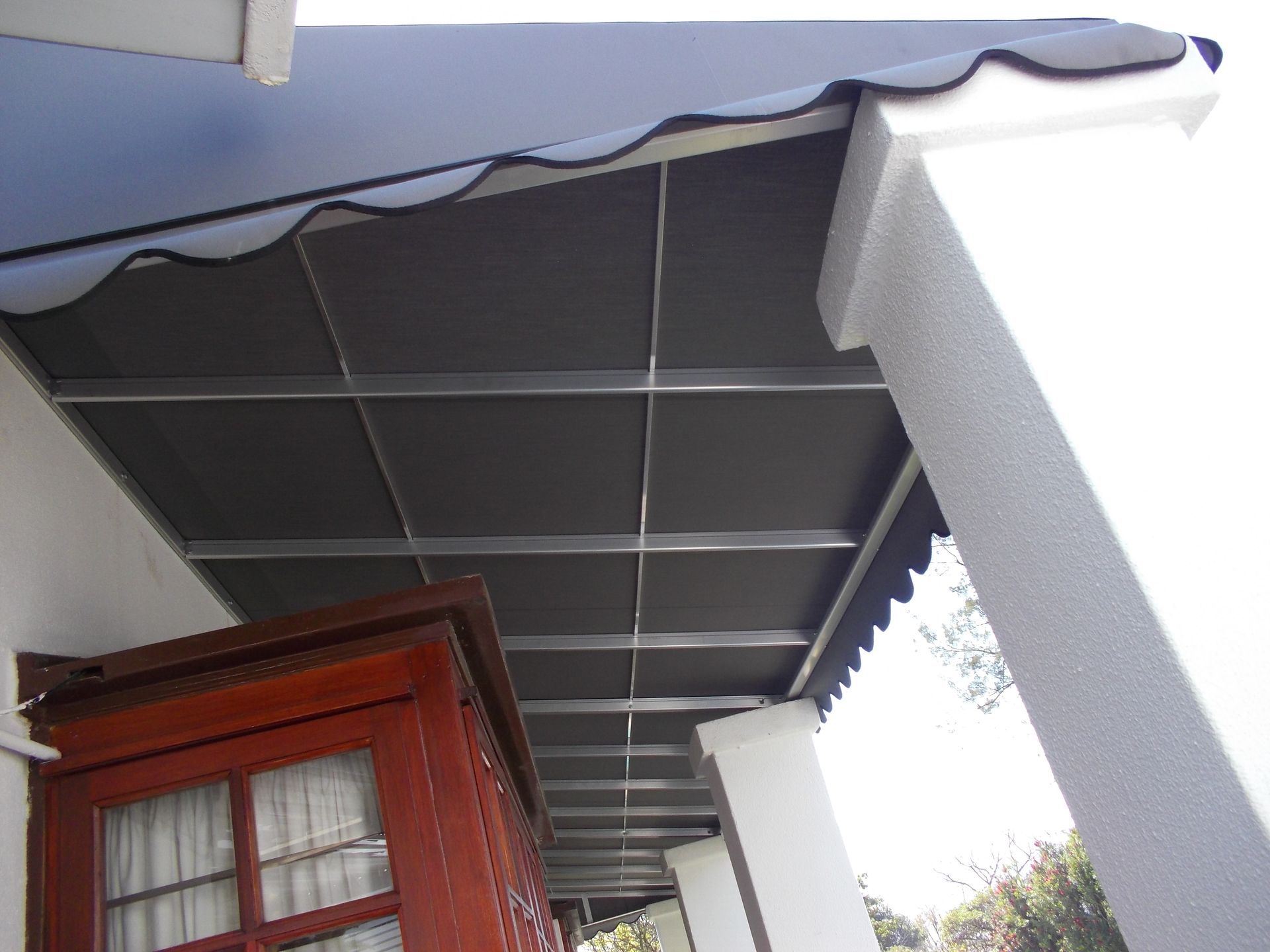 Canvas fold arm awning extended over a South African residential patio — Awning Warehouse