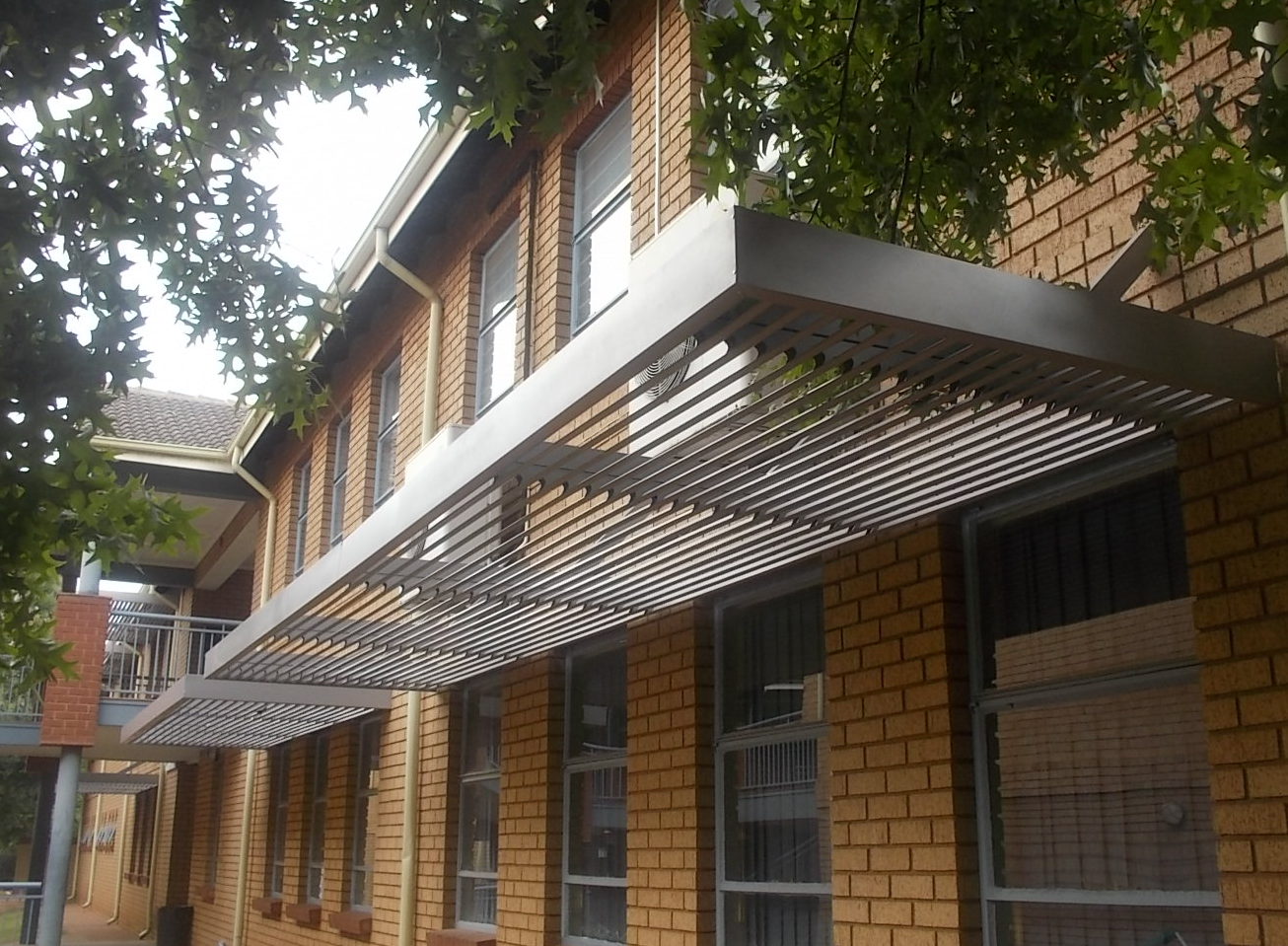 Branded commercial awning installed on a South African retail shopfront — Awning Warehouse