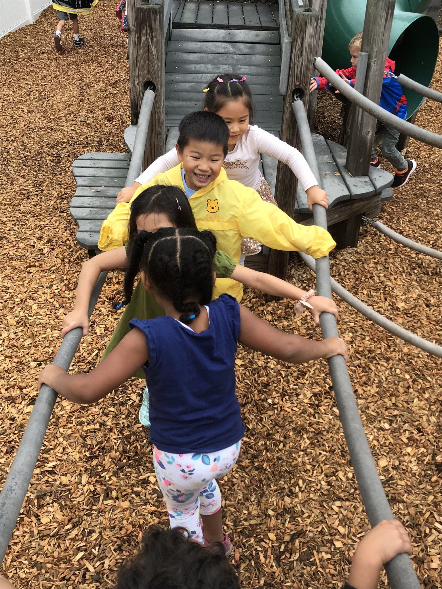 A group of children are playing on a playground.