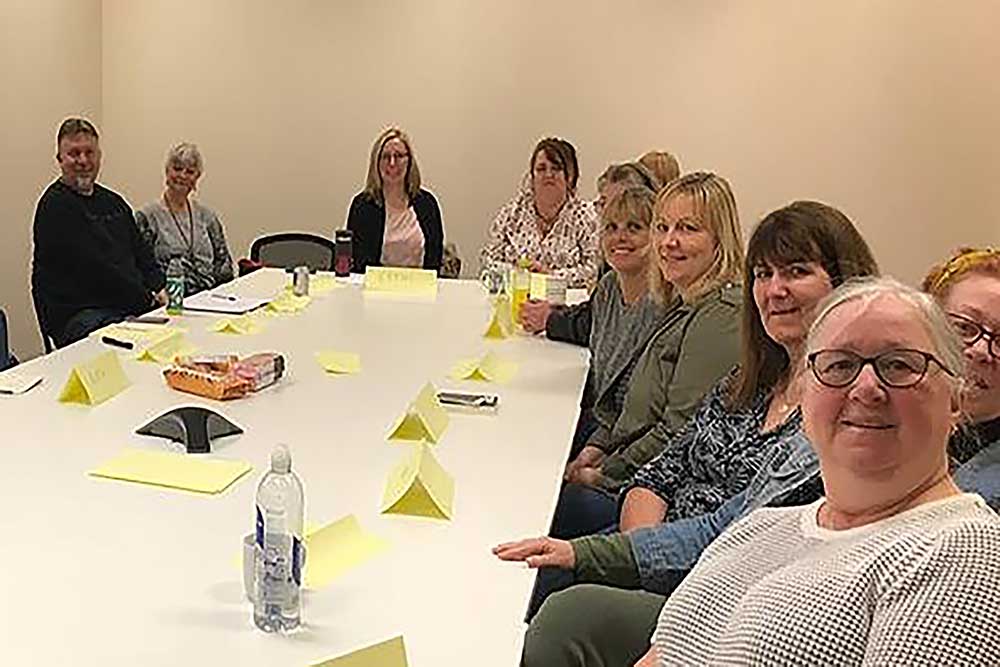 The NODA team sitting round a table