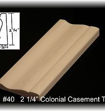 Beige 2¼-inch colonial casement trim molding on a black background with size label.