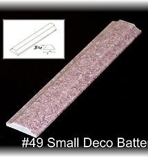 Pink glittery decorative baton on black background, with small sketch inset and label 