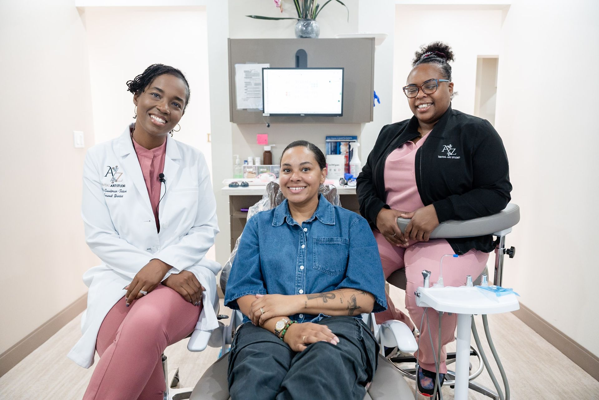 Patient seated in a dental chair while a dentist reviews digital dental scans on a monitor during a sleep and airway evaluation.