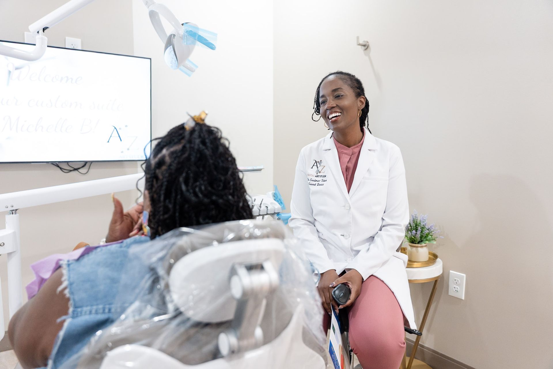 Dentist consulting with a seated patient in a bright exam room