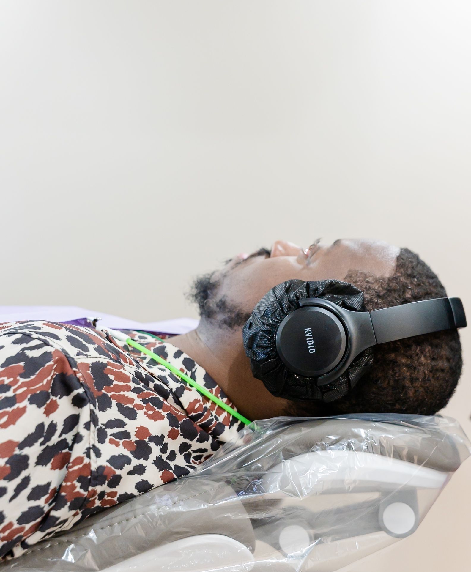 Dentist examining a patient reclined in a dental chair during an evaluation for snoring and sleep-related breathing concerns.