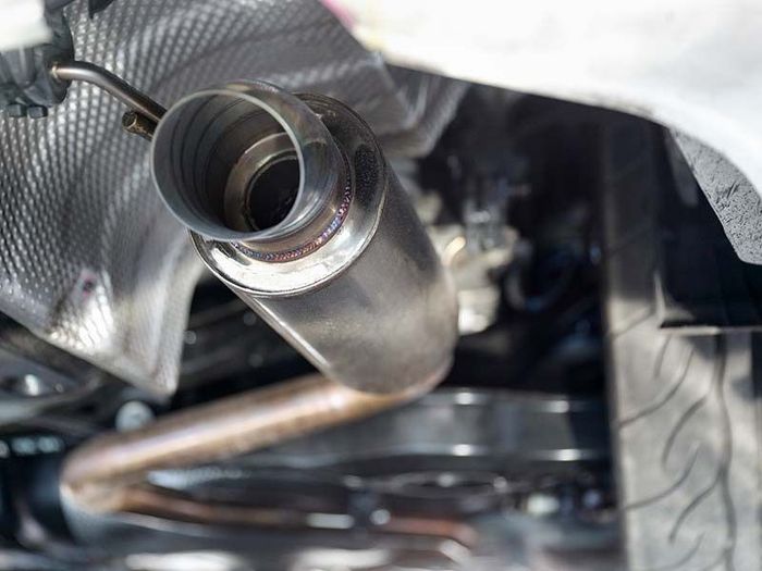 Silver car exhaust pipe, undercarriage view.