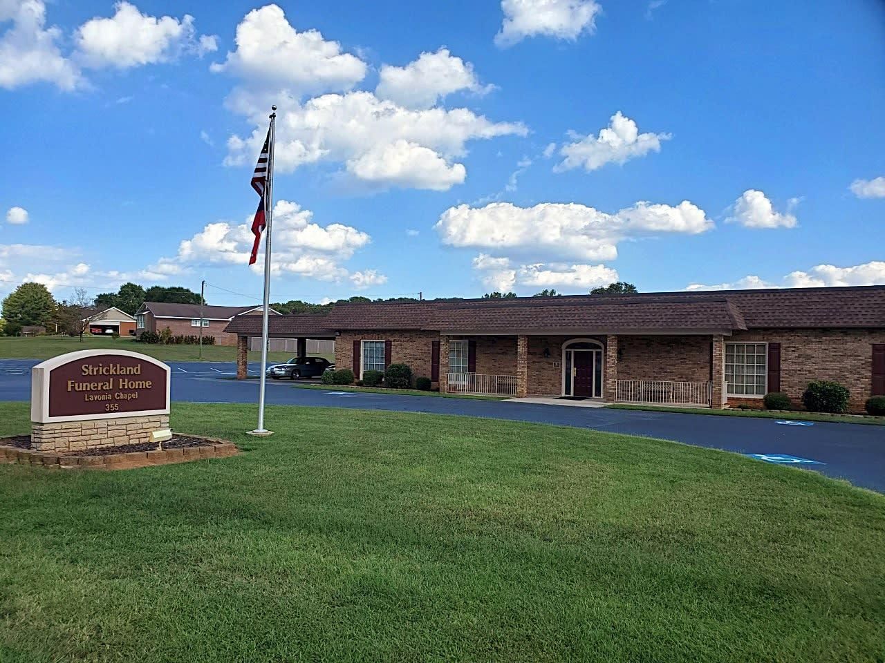 Exterior view of a brick building with a sign that says 