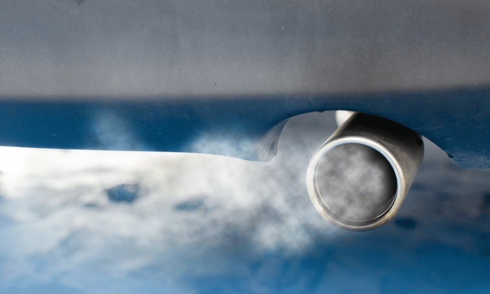 Car exhaust pipe releasing visible emissions from tailpipe