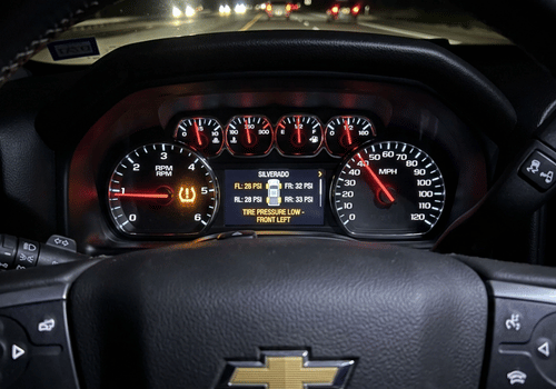 Chevrolet dashboard displaying a low tire pressure warning and TPMS alert