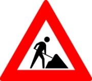 Rood driehoekig bord met wegwerkzaamheden en een afbeelding van iemand die naast een hoop aarde aan het graven is.