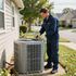 Certified Comfort of Georgia technician working on an hvac unit outside of a duplex neighborhood