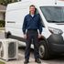 Certified Comfort of Georgia technician standing outside of a van in commercial business parking lot after repairs were done