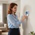 woman adjusting the thermostat in athens ga
