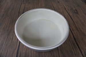 White ceramic bowl on a wooden surface.