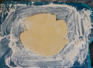 Abstract painting with a yellow center surrounded by white and blue brushstrokes