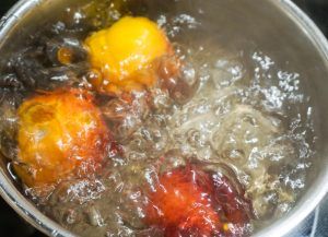 Three colorful fruits boiling in a pot of water