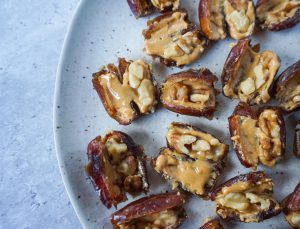 Close-up of chopped dates stuffed with walnuts on a white plate