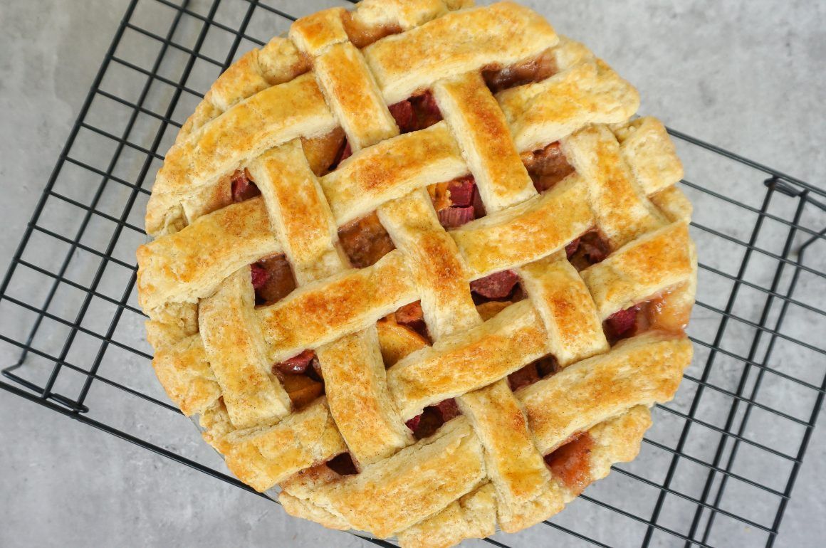 Golden lattice-top pie cooling on a wire rack, viewed from above
