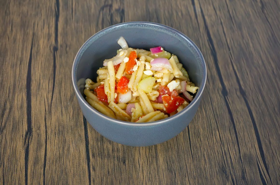 Small gray bowl of mixed vegetables on a wooden table