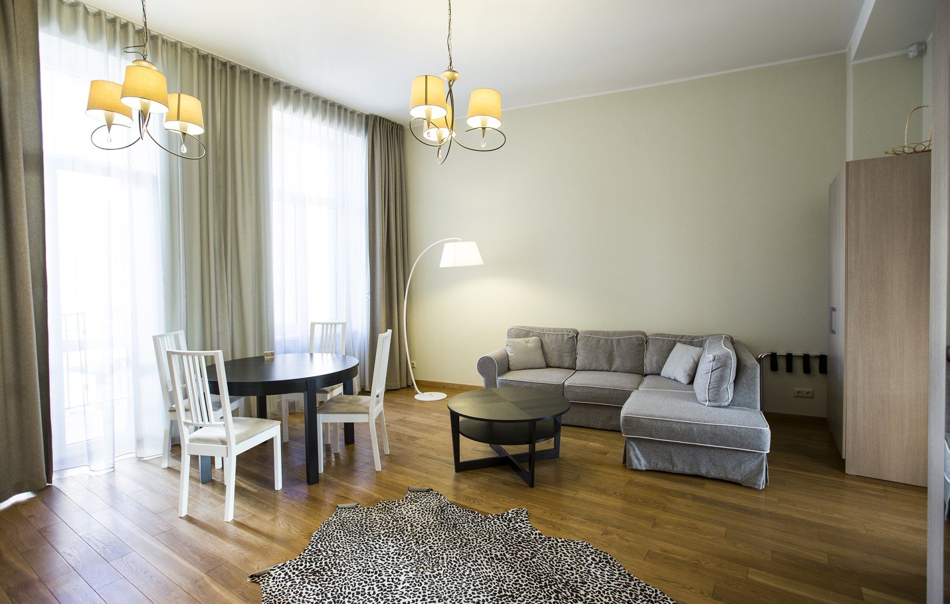 A living room with a couch a table and chairs