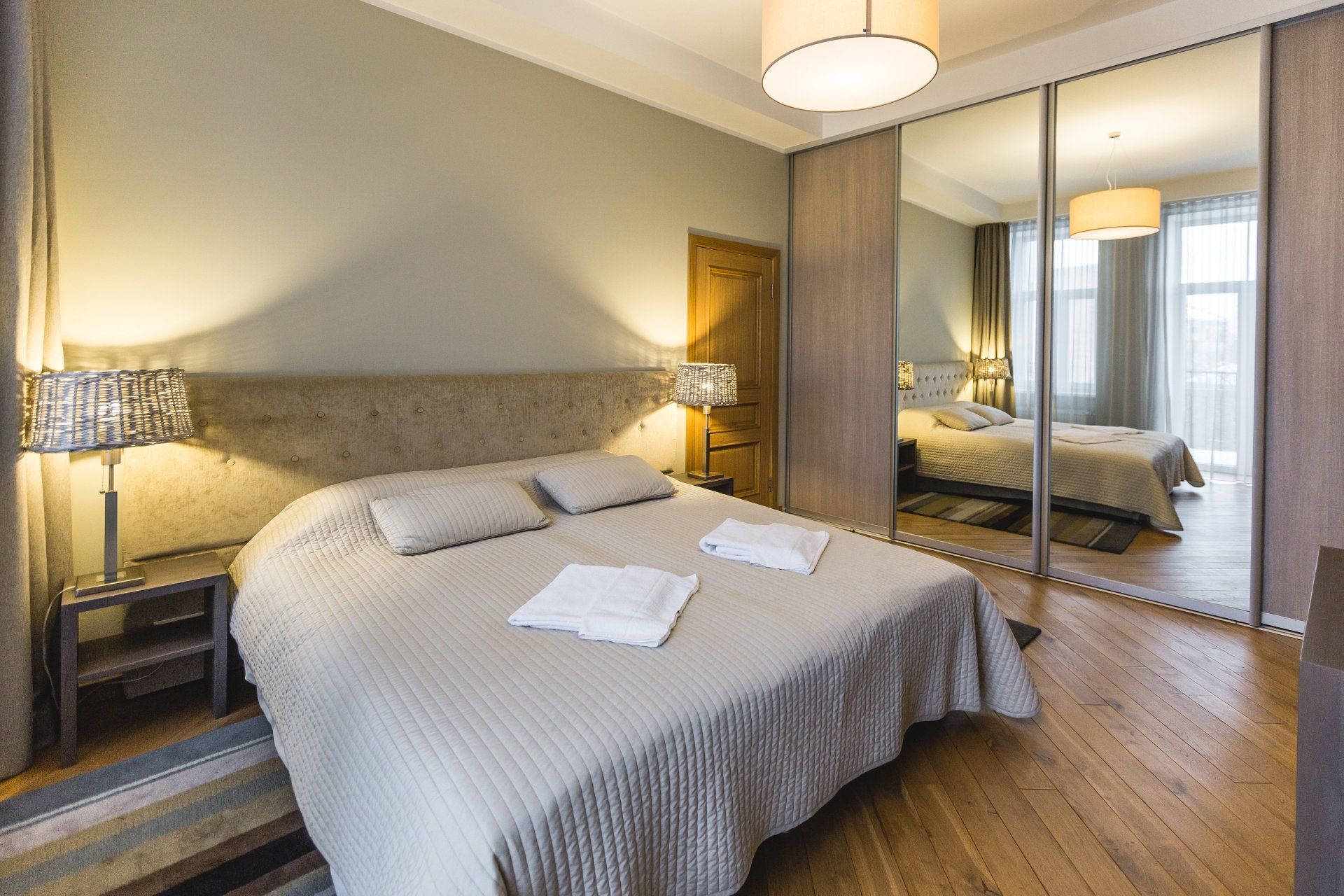 A bedroom with a king size bed and sliding glass doors.