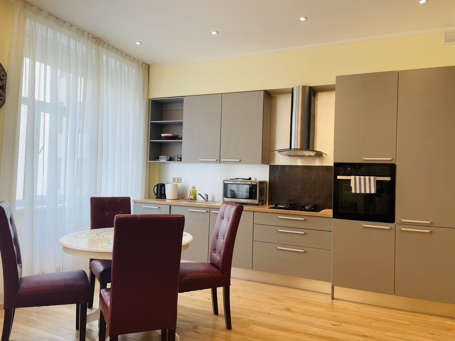 A kitchen with a table and chairs in it