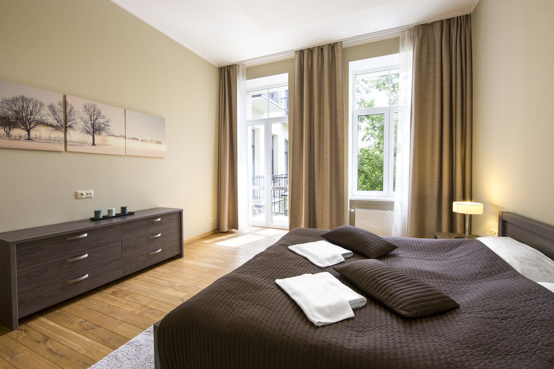 A bedroom with a large bed and a dresser