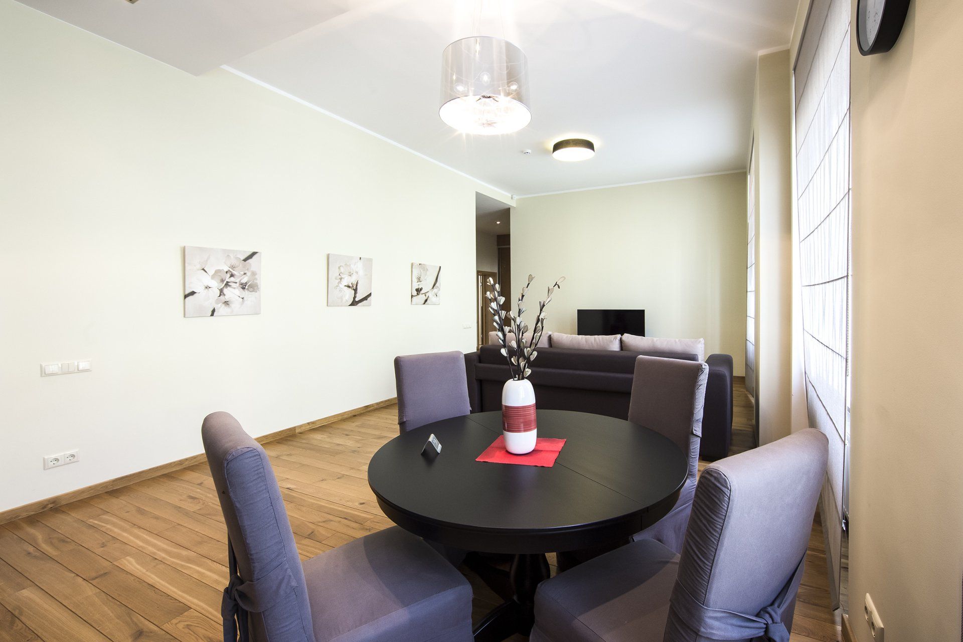 A living room with a table and chairs in it