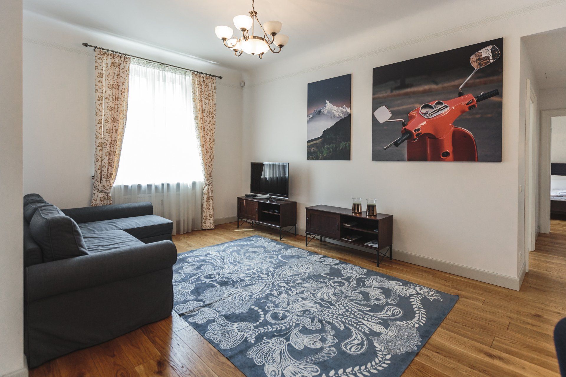 A living room with a couch and a rug