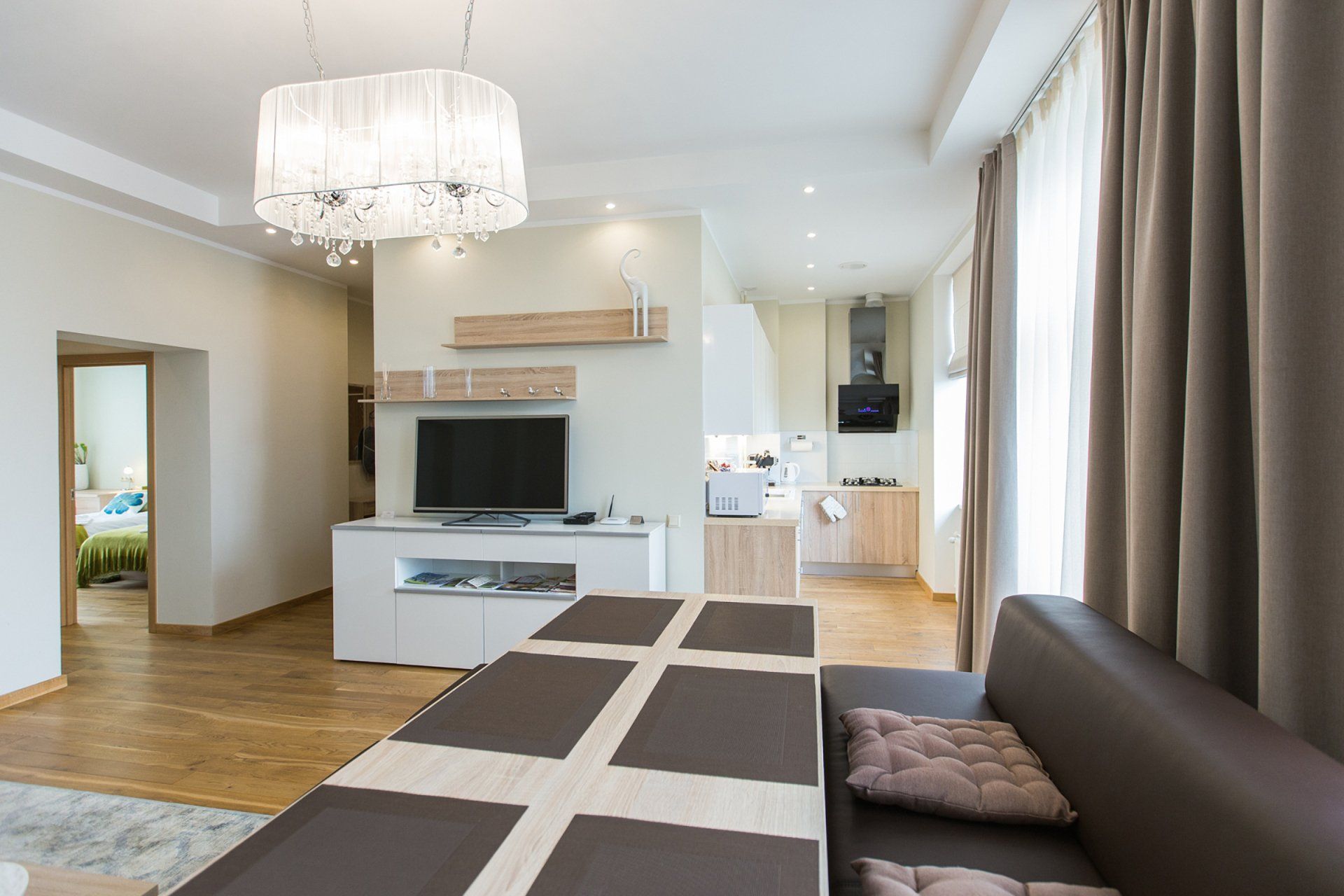 A living room with a couch , table and television.