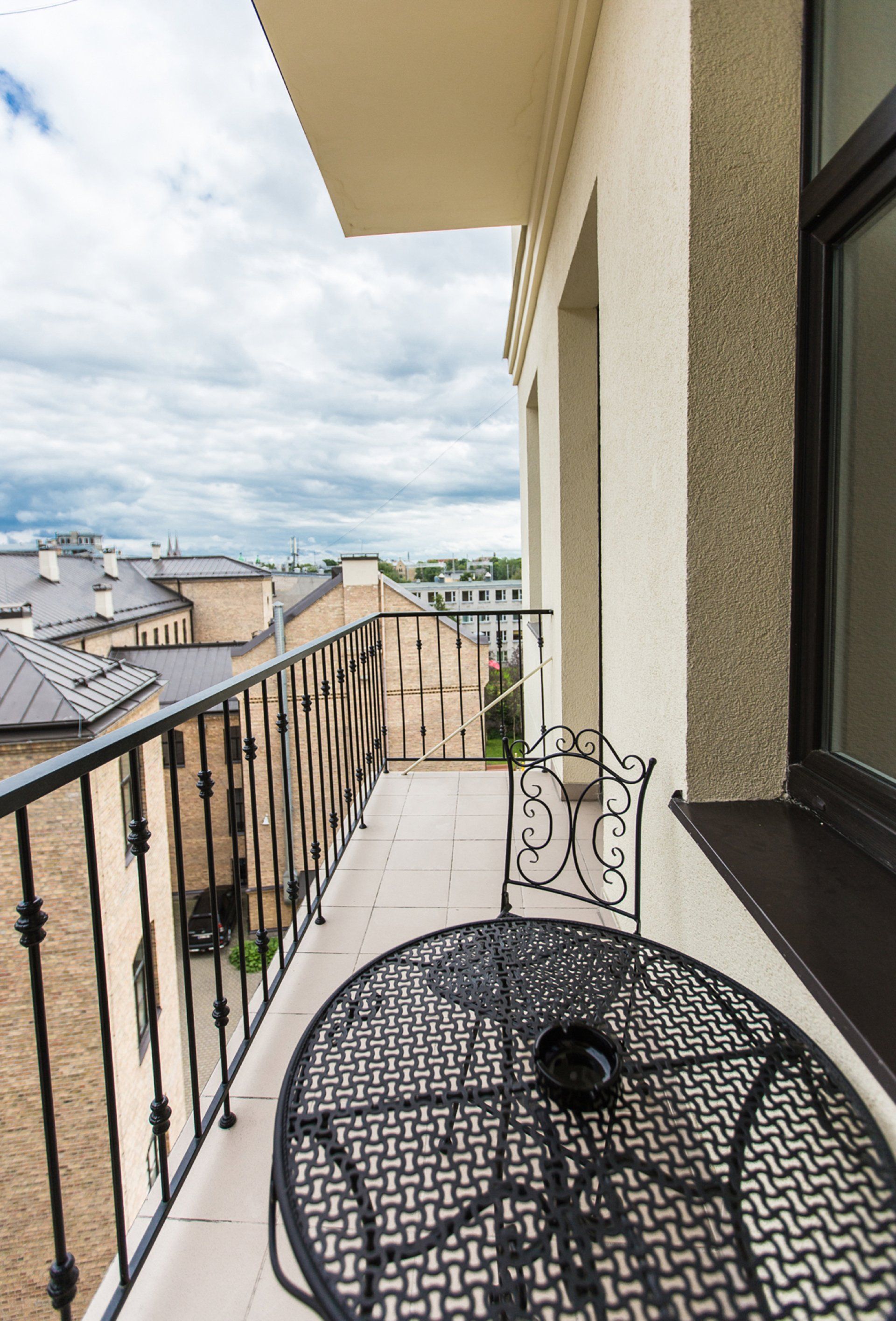 There is a table and chair on the balcony.
