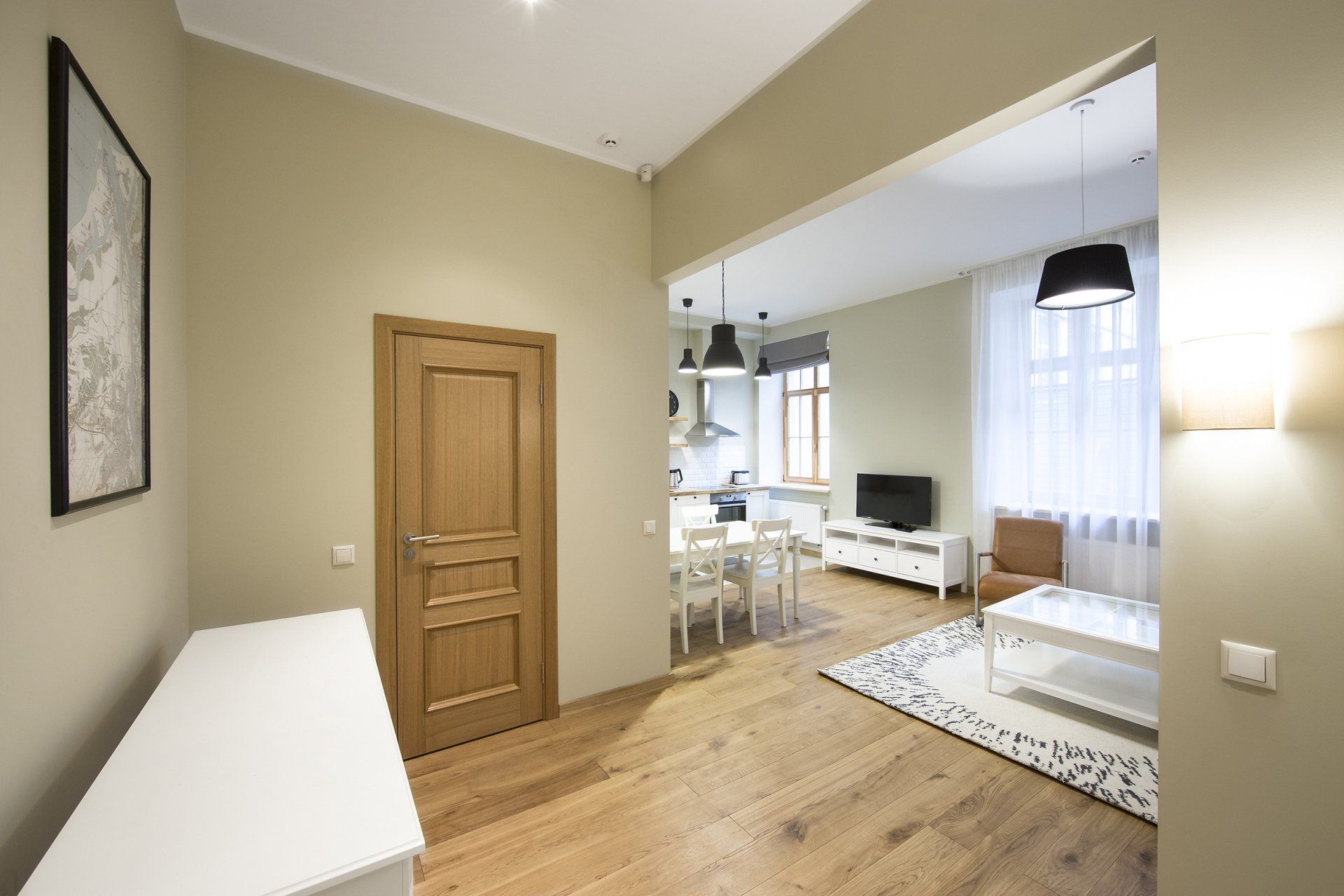 A living room with hardwood floors and a wooden door