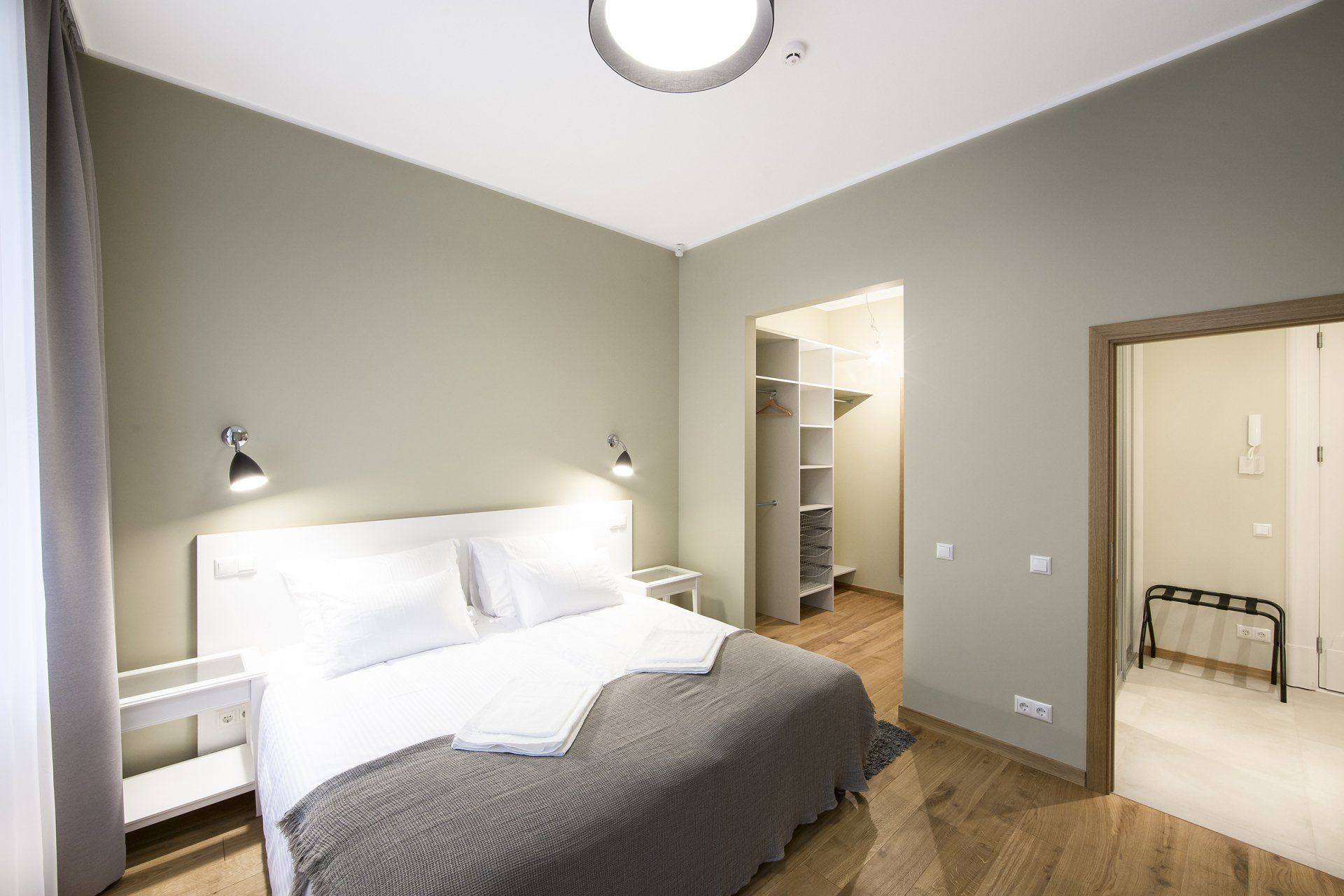 A bedroom with a large bed and a walk in closet.