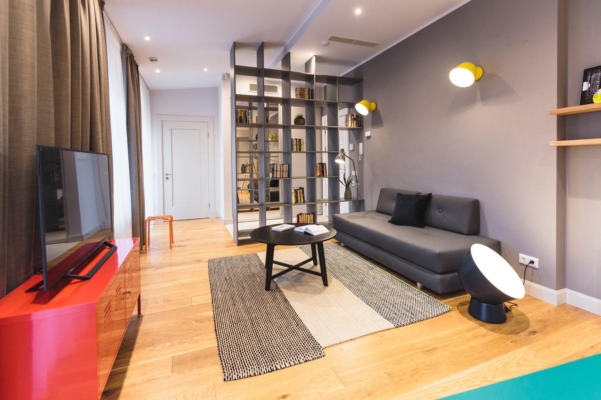 A living room with a couch , table , and television.