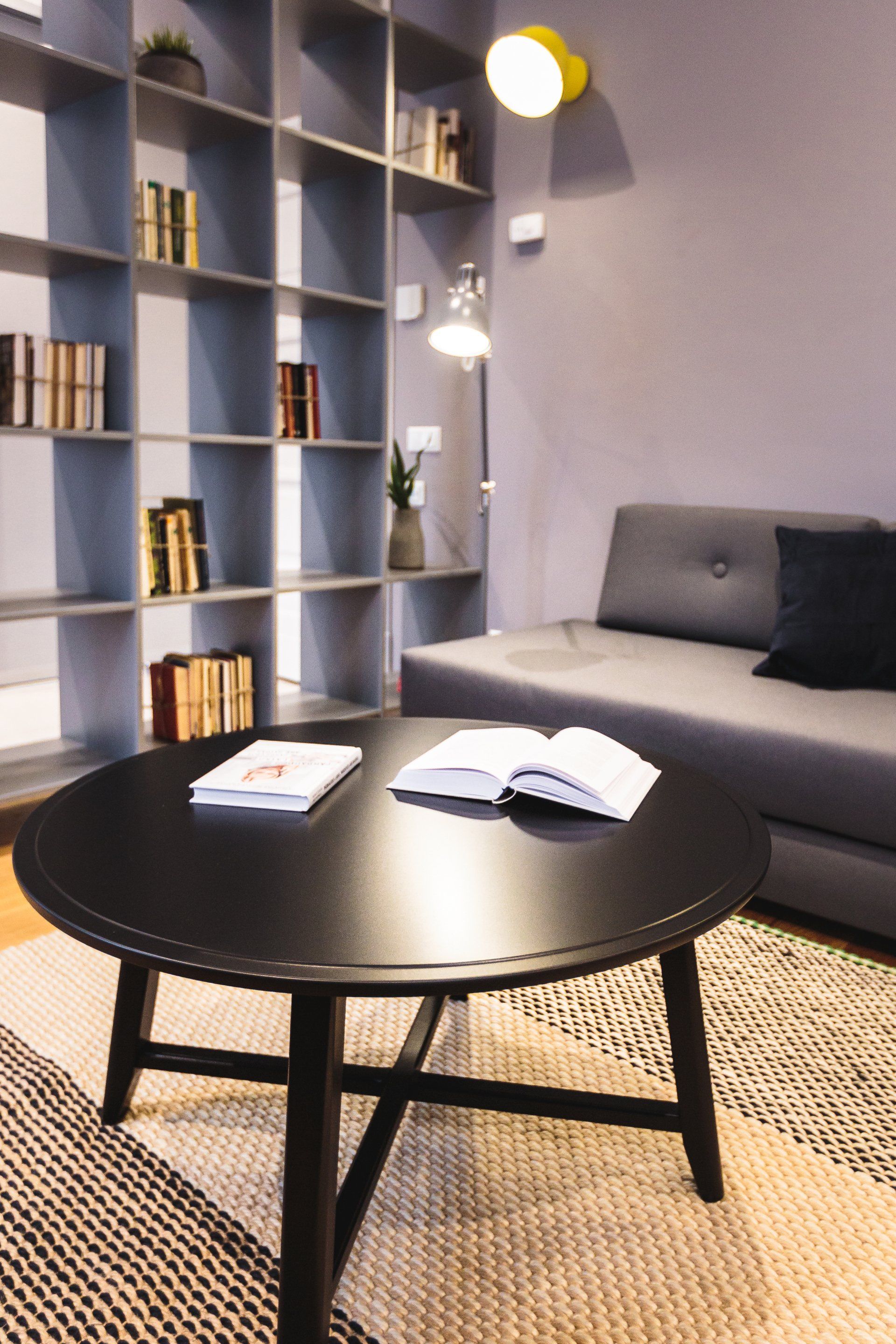 A living room with a couch and a table with a book on it