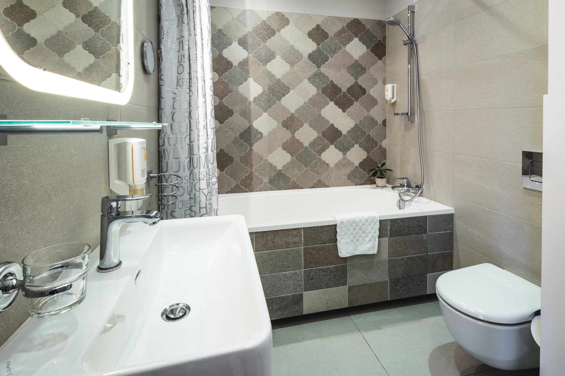 A bathroom with a sink , toilet and bathtub.