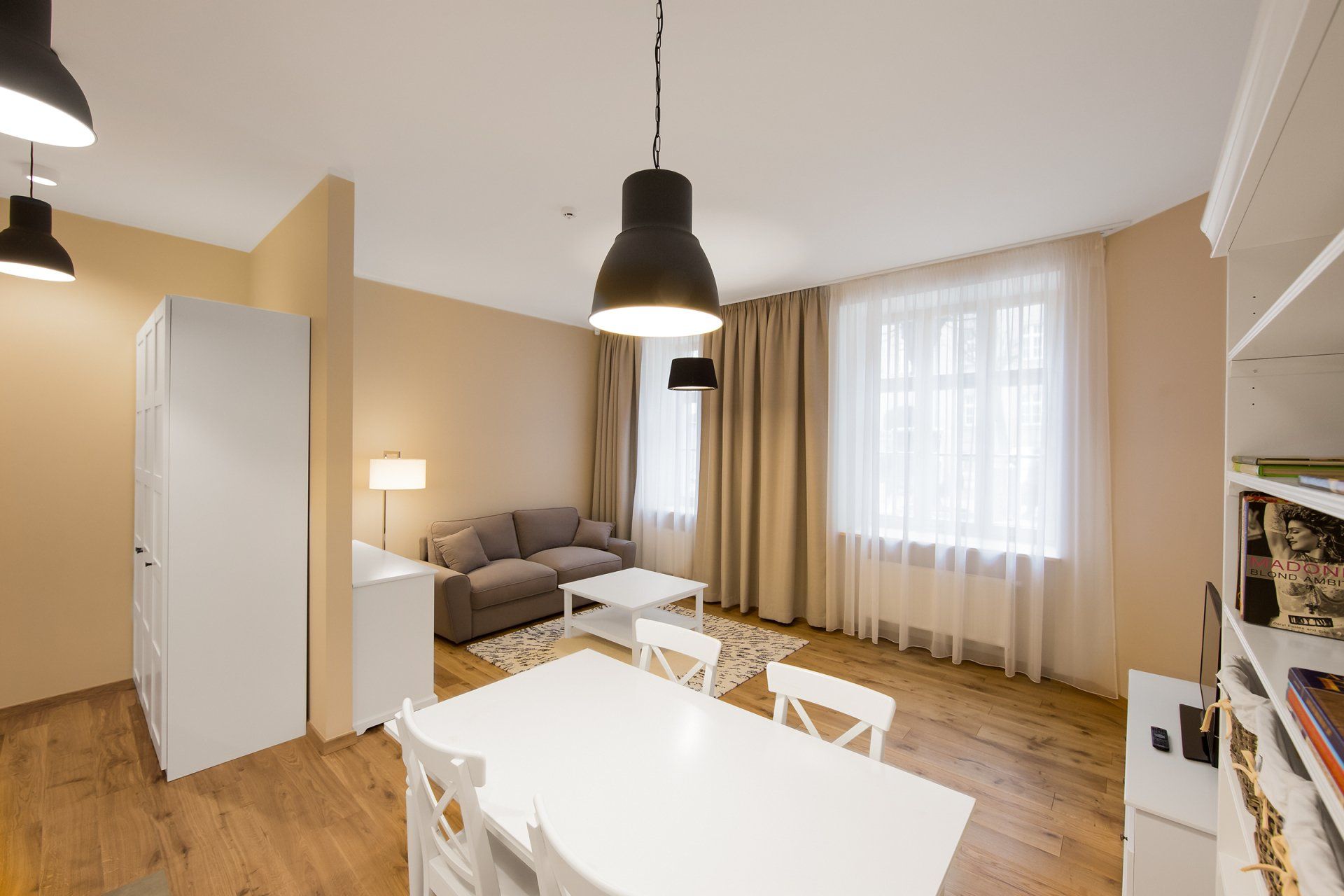 A living room with a table and chairs and a couch