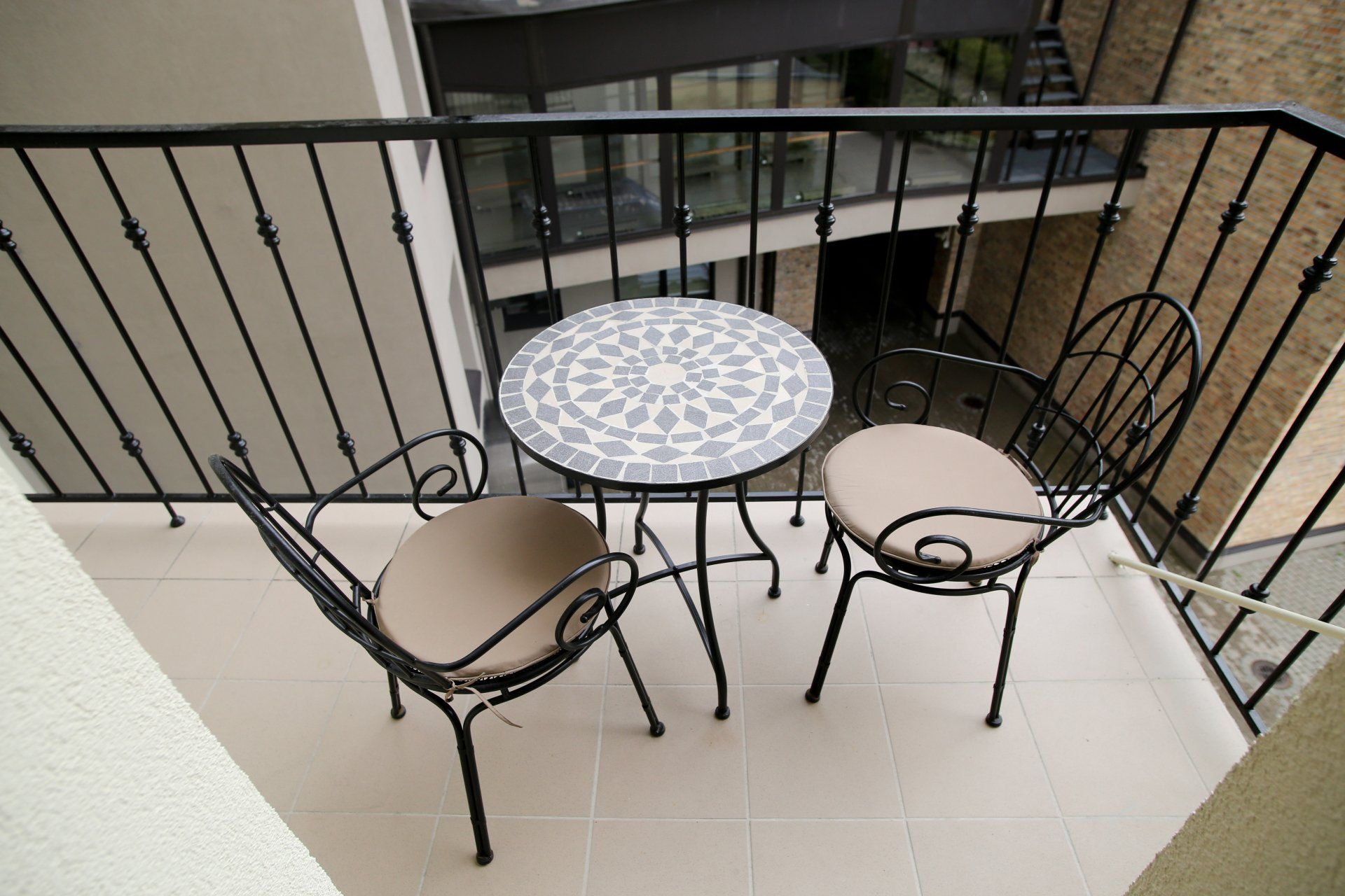 A balcony with a table and chairs on it