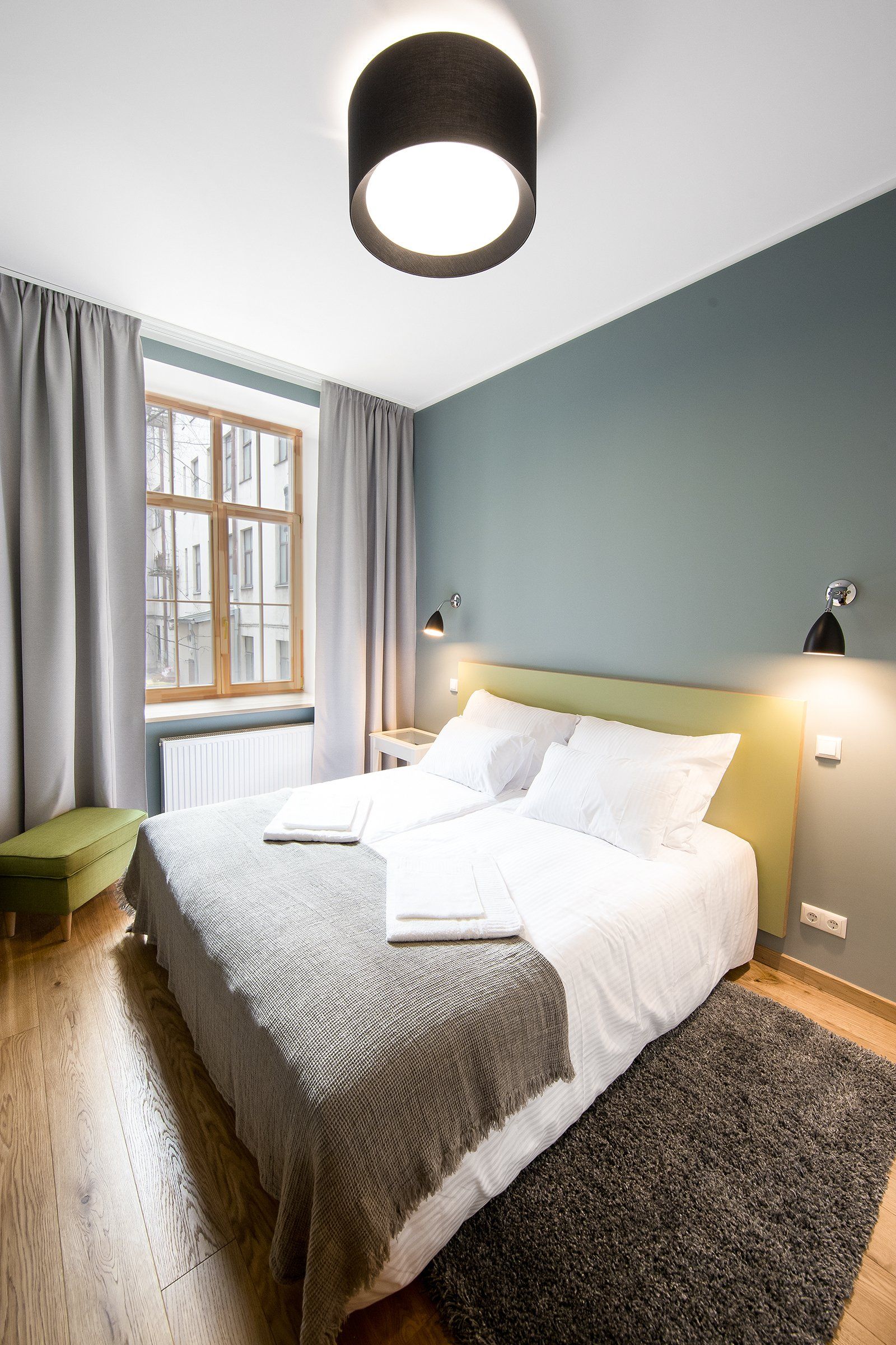 A bedroom with a large bed and a window.