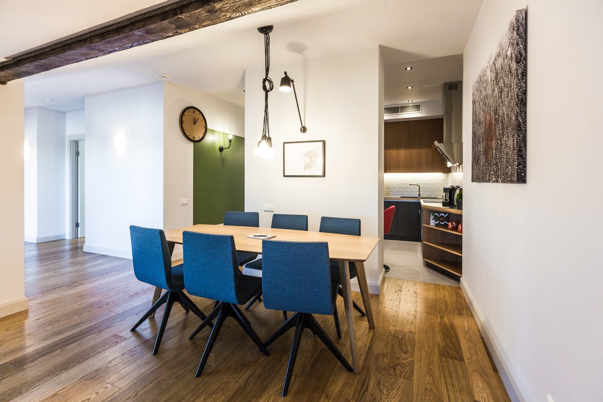 A dining room with a wooden table and blue chairs